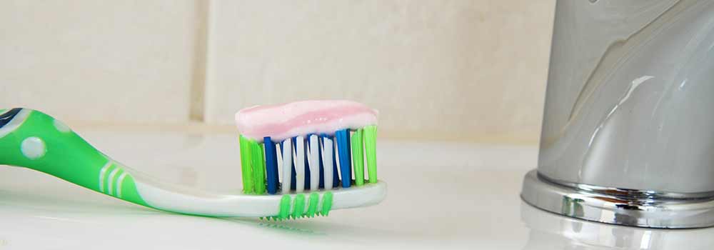 Natural toothpaste on toothbrush
