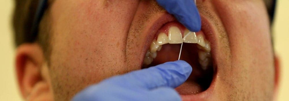 Person having their tooth flossed