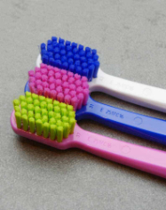 3 manual toothbrushes next to each other