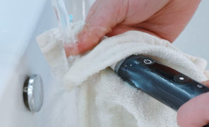 Toothbrush being cleaned under running water
