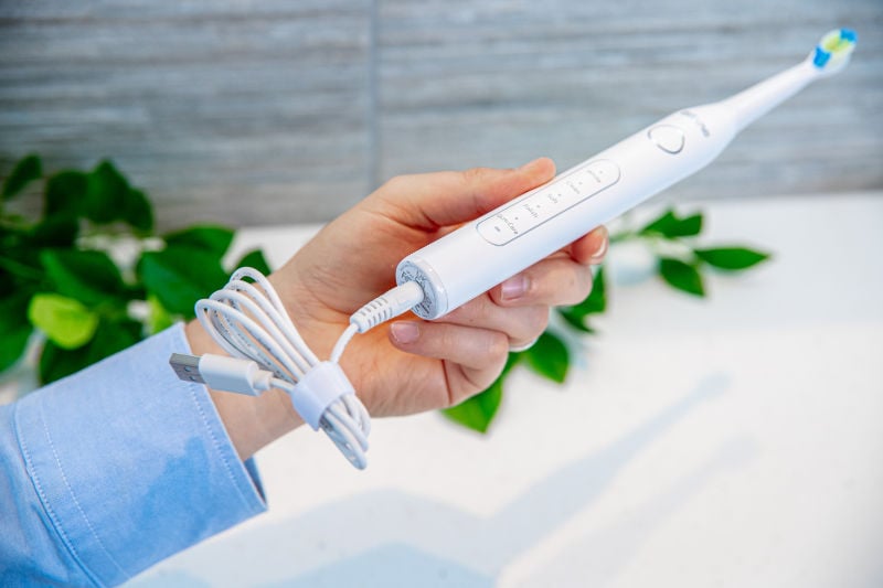 Bitvae D2 toothbrush with charger plugged into bottom