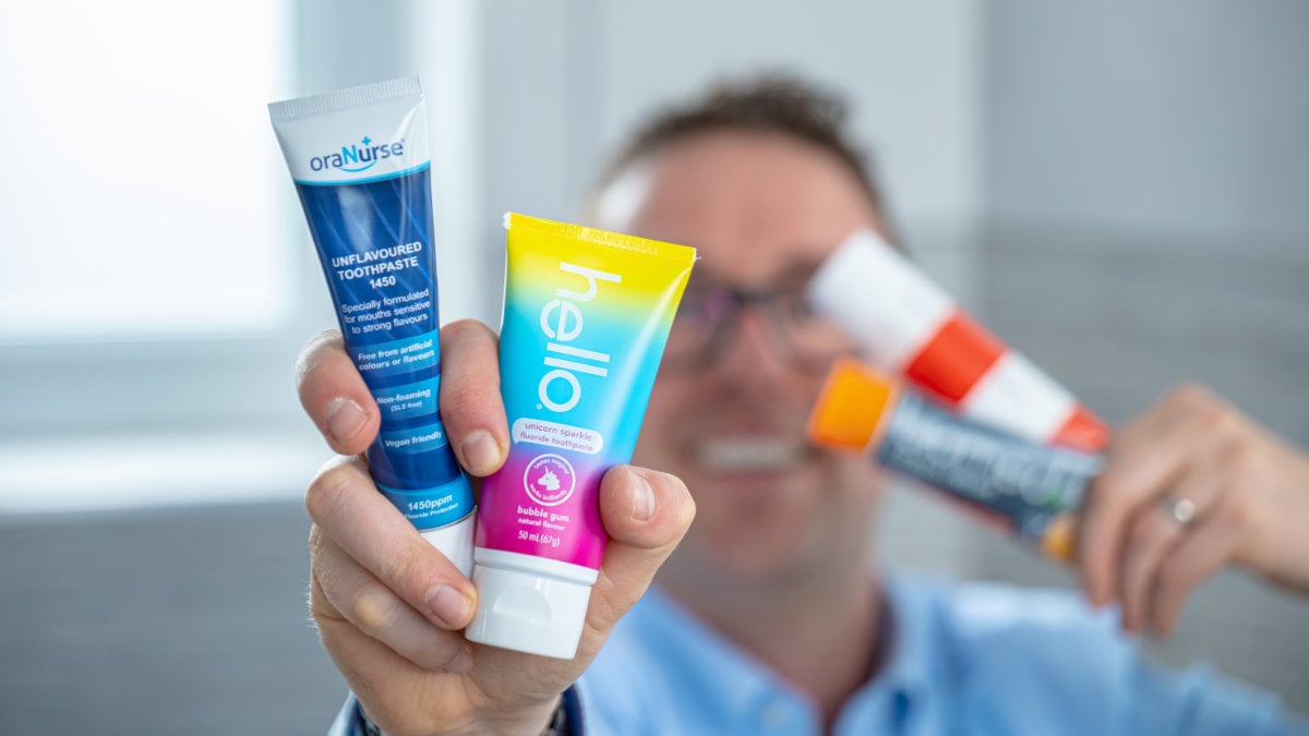 Jon holding non mint toothpastes to camera