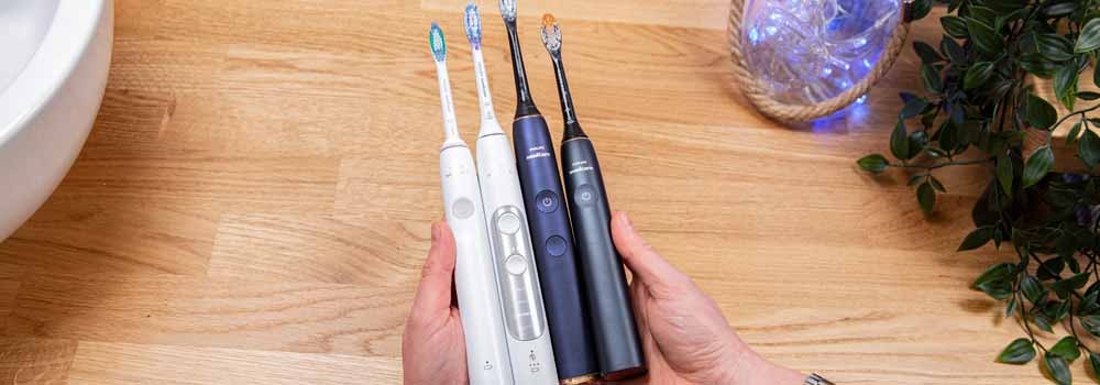 Sonicare toothbrushes being compared in hand