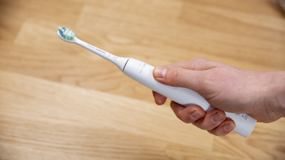 Sonicare 4100 Series button being pressed