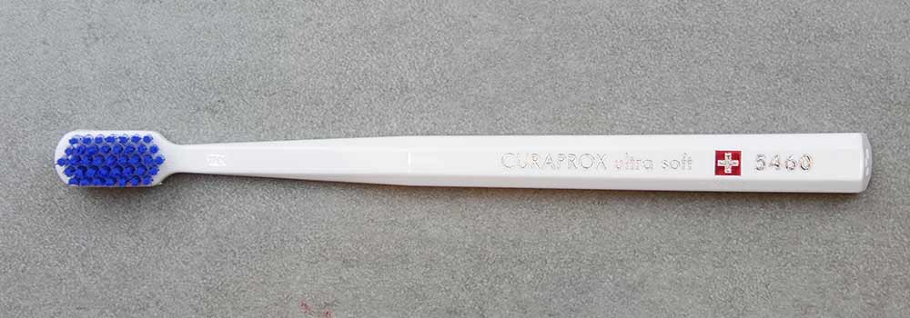 Full width shot of white and blue Curaprox brush