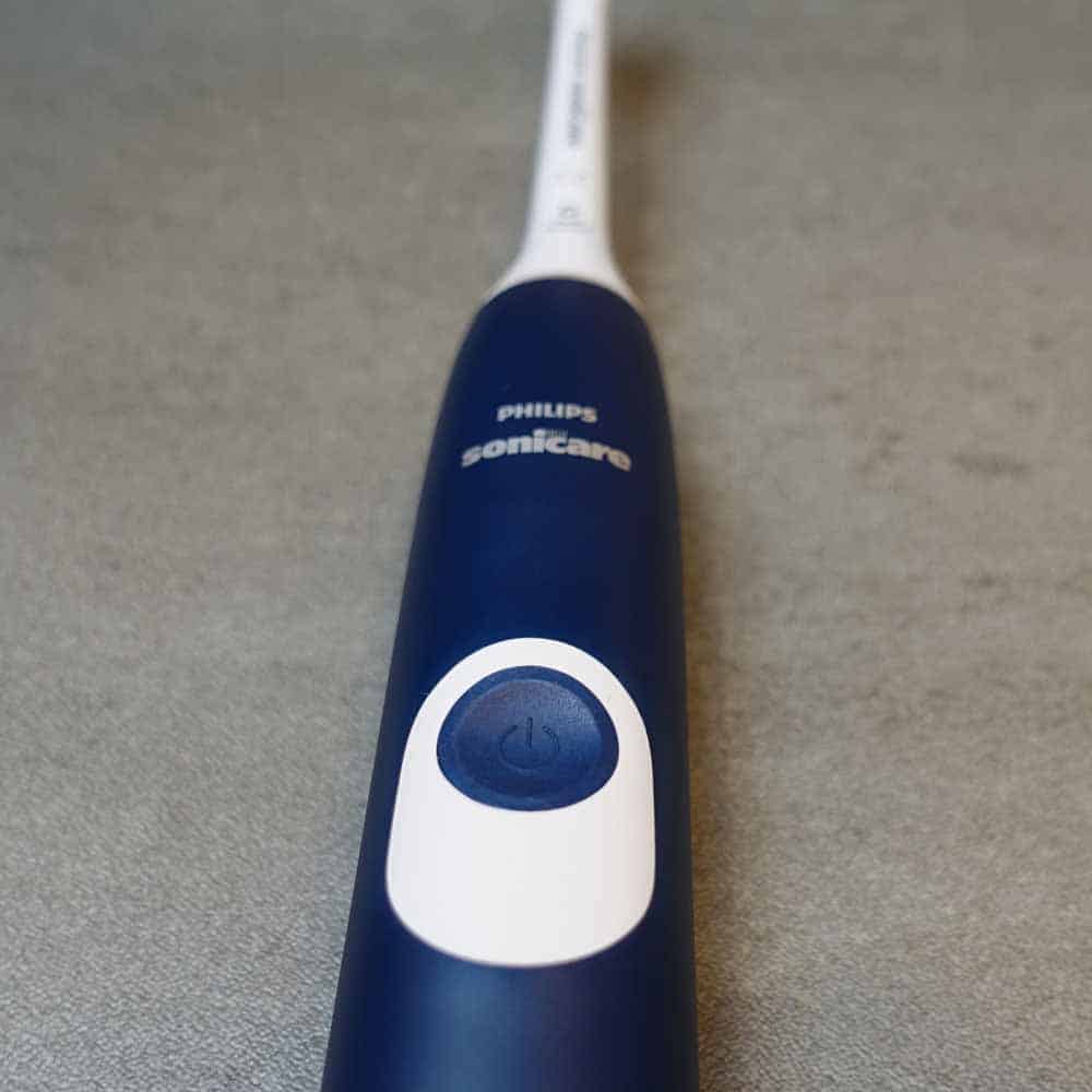 Close up view of the power button and upper half of the ProtectiveCLean 4300 toothbrush