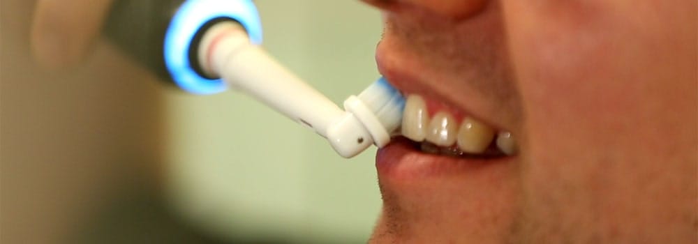 An electric toothbrush brushing teeth