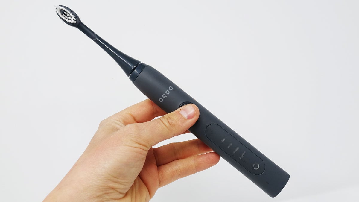 Ordo Sonic + toothbrush in hand