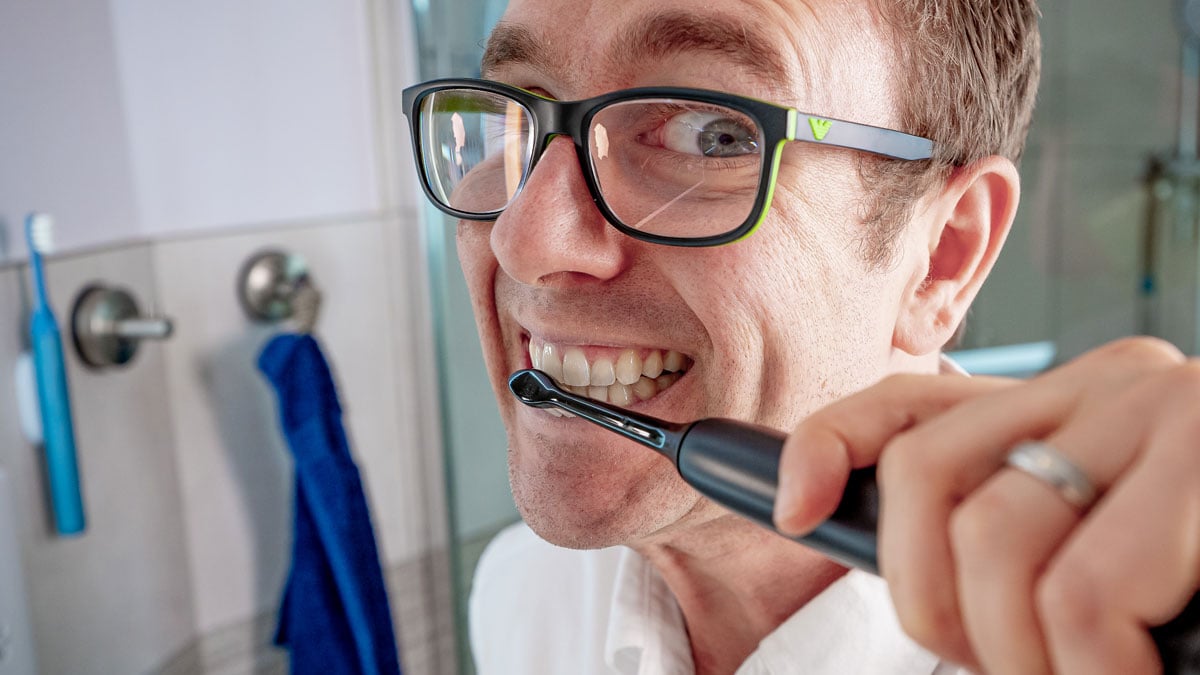 Man brushing teeth with Sonicare 4100 Series