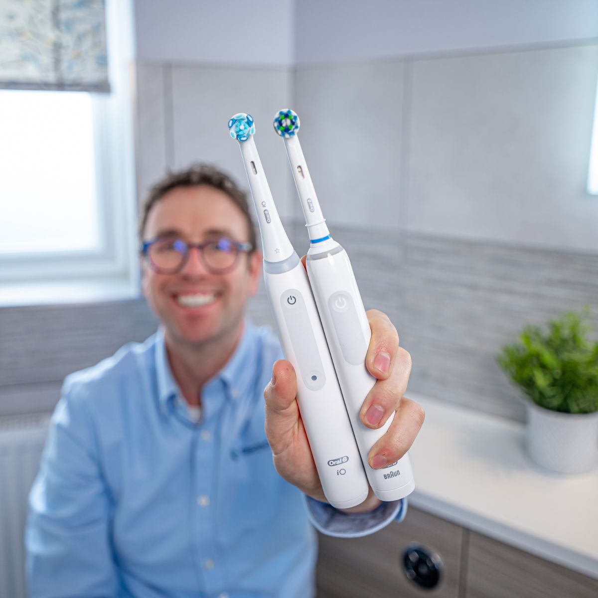 Jon holding the iO Series 3 and the Pro 3 from Oral-B.