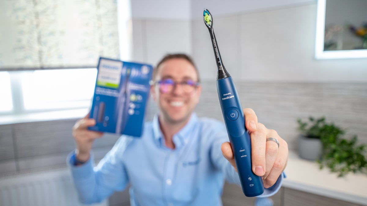 Jon holding the Sonicare Series 5500 to camera with box in the background
