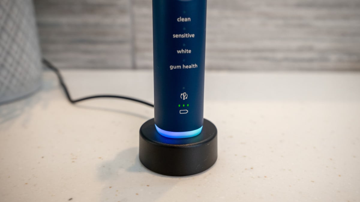 Sonicare Series 7100 on charging stand showing light ring illuminated and battery status LED icons