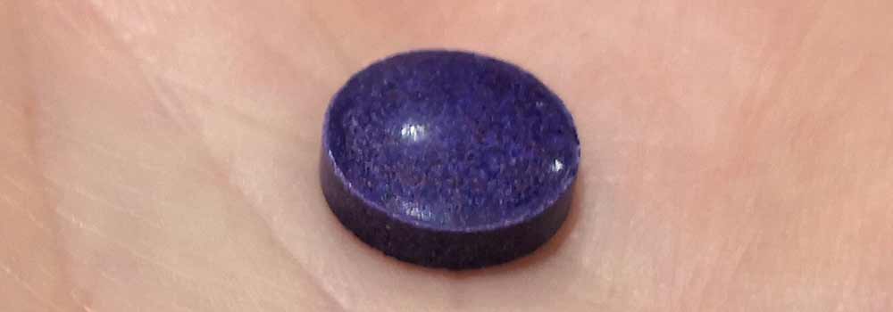 Purple colored plaque disclosing tablet