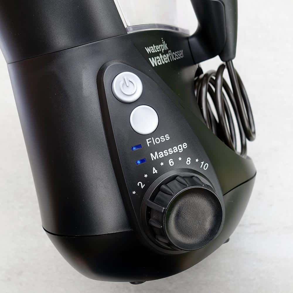 Power and mode buttons alongside the control dial for changing pressure of water flow on Waterpik Aquarius