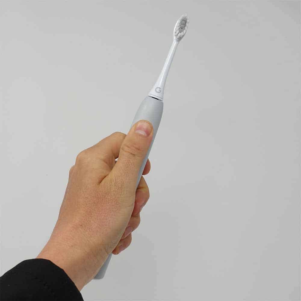 GLEEM toothbrush held in hand