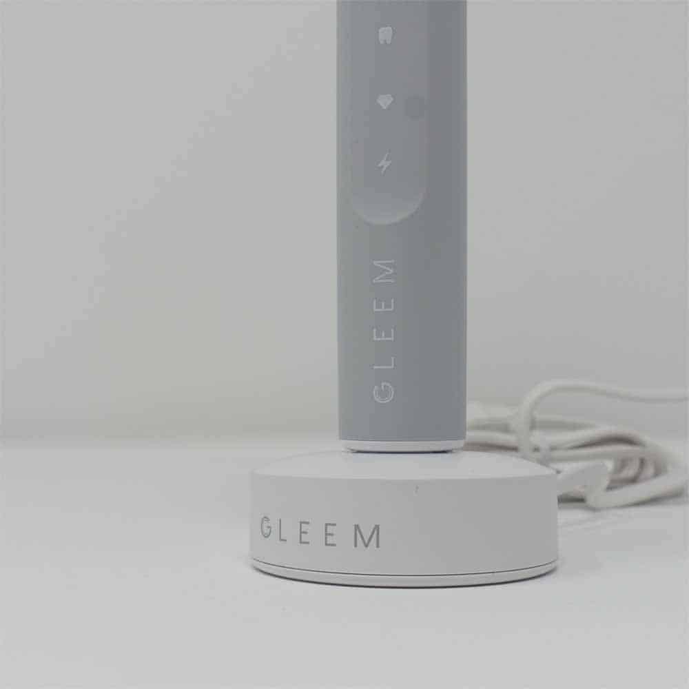 GLEEM rechargeable toothbrush on charging stand