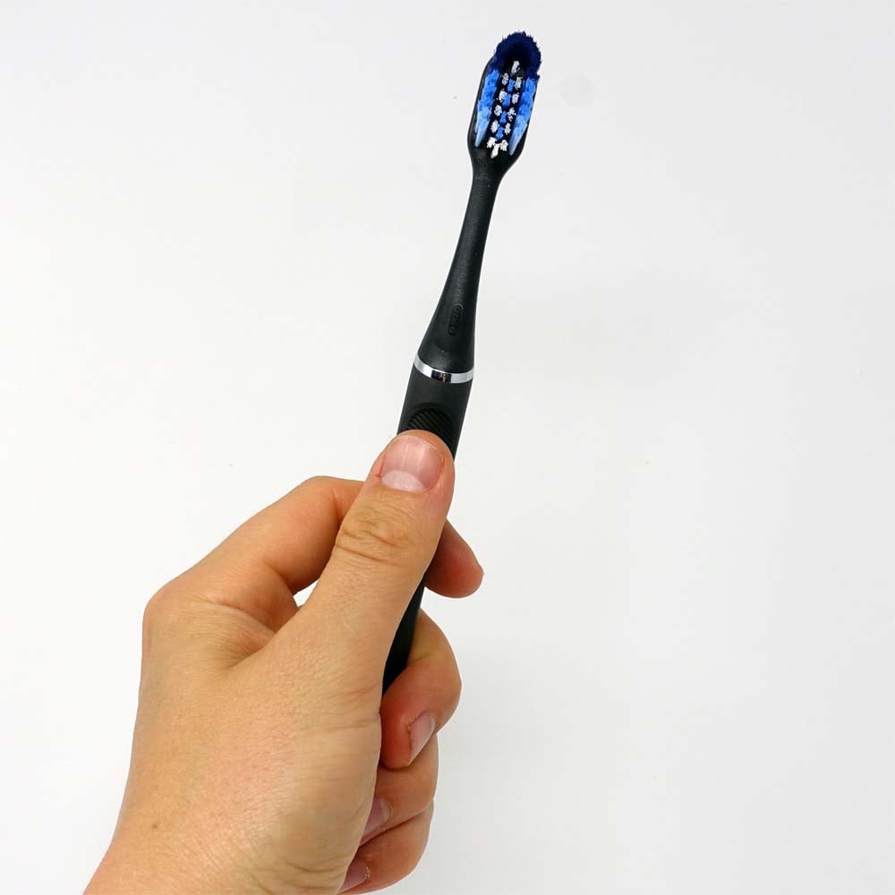 Matte black Oral-B Clic in hand