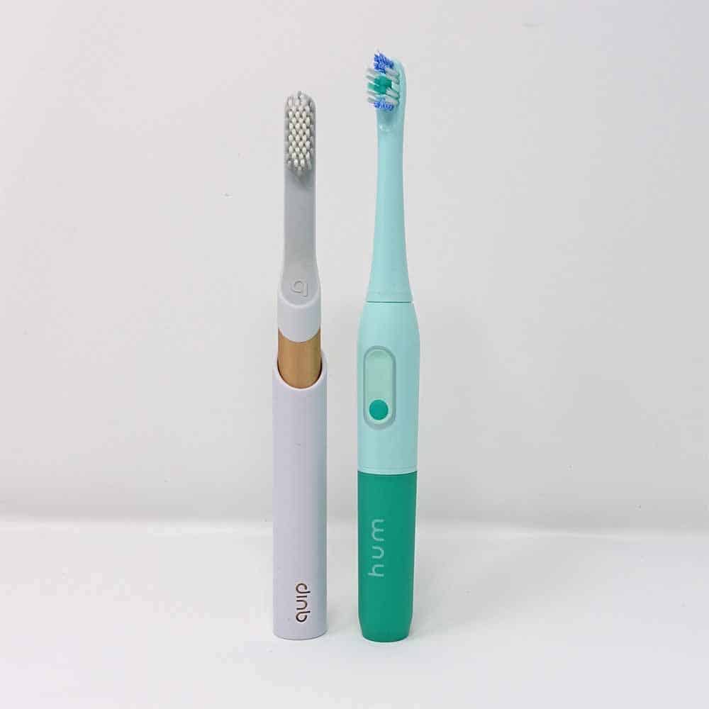 Quip Toothbrush Stood Next To Hum By Colgate