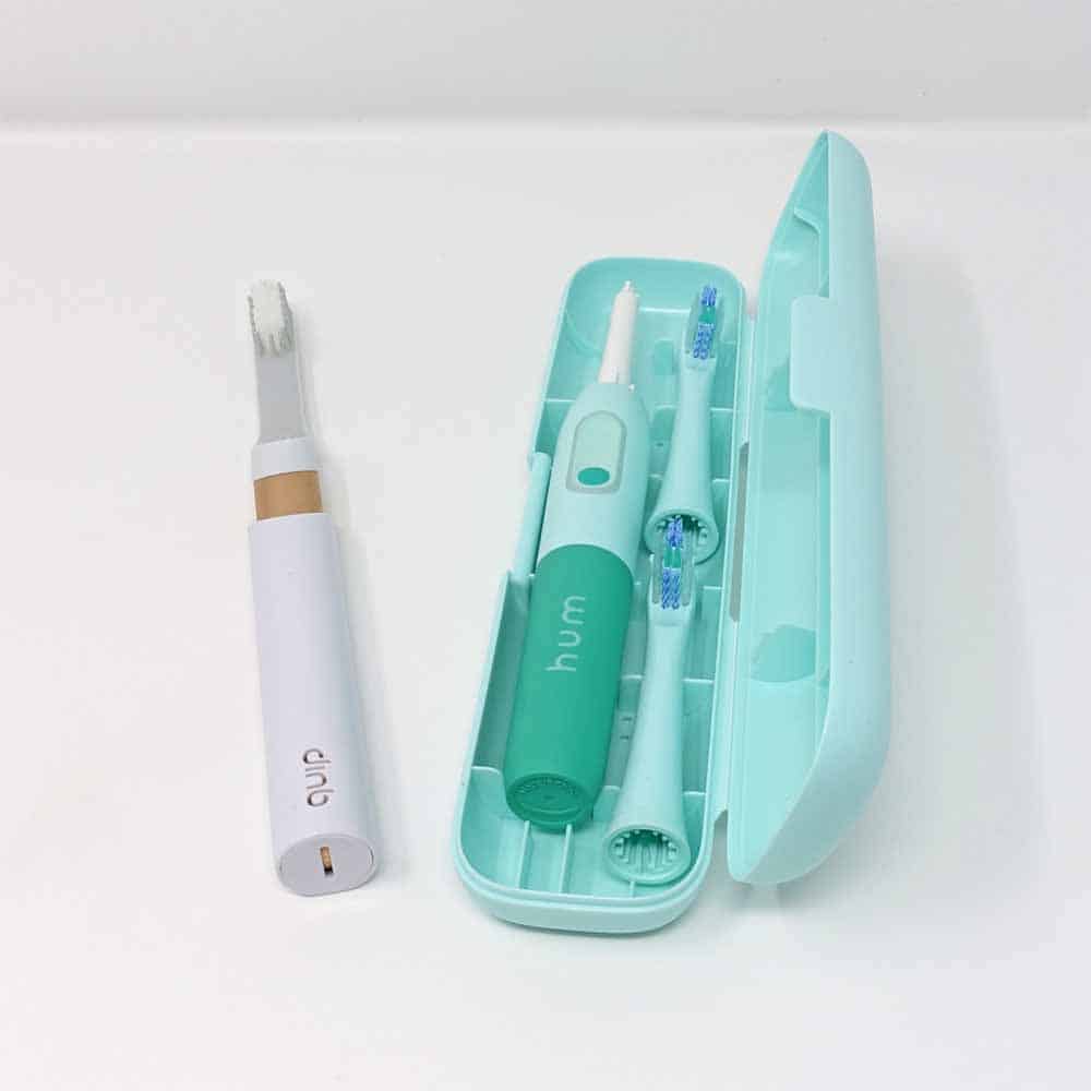 Quip & Hum toothbrush in travel cases