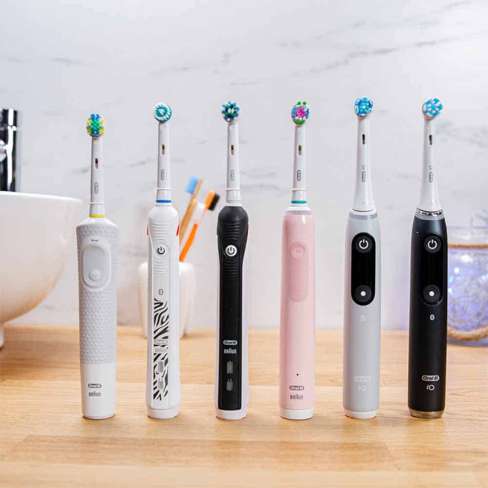 Range of Oral-B electric toothbrushes side by side on tabletop