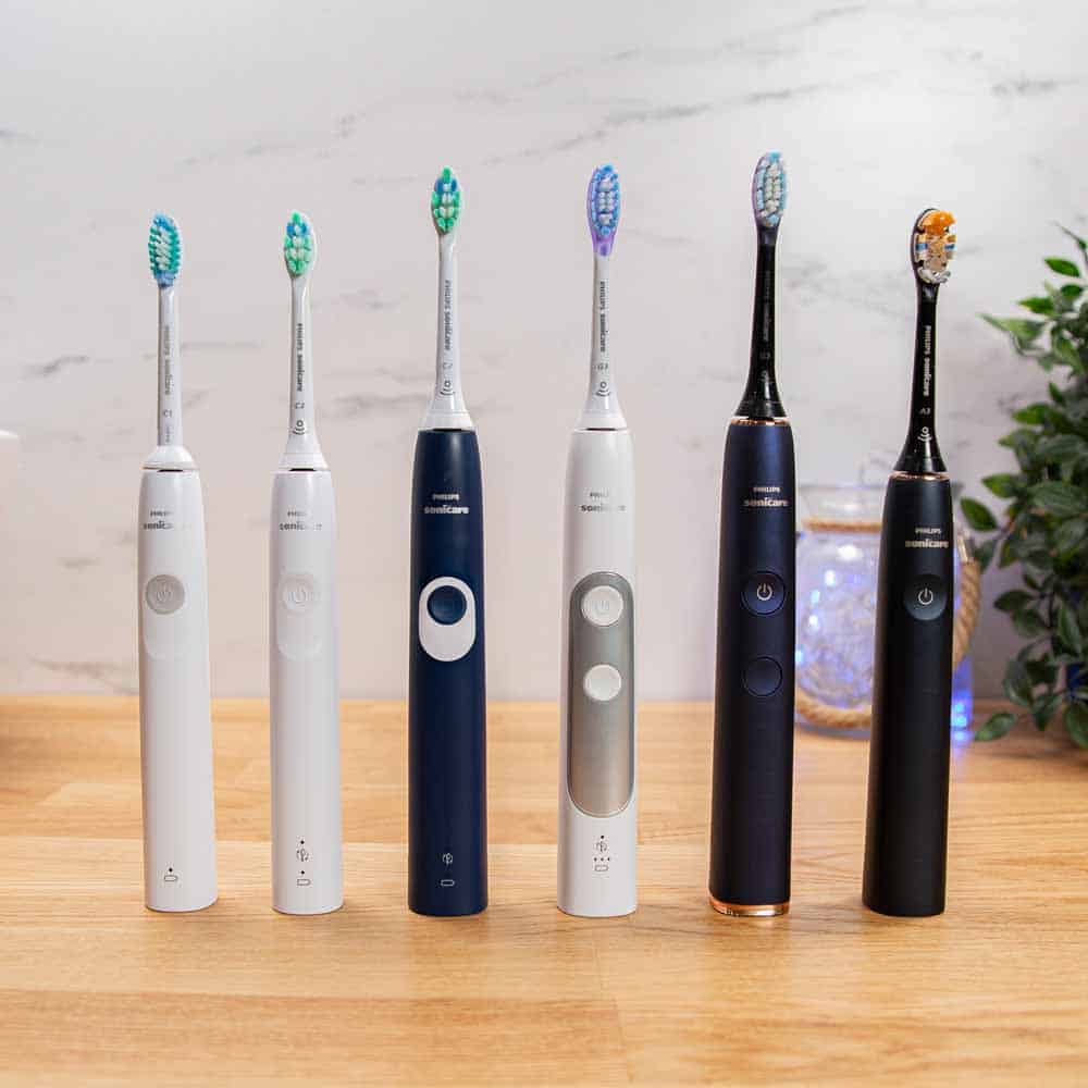 Sonicare electric toothbrushes stood next to each other