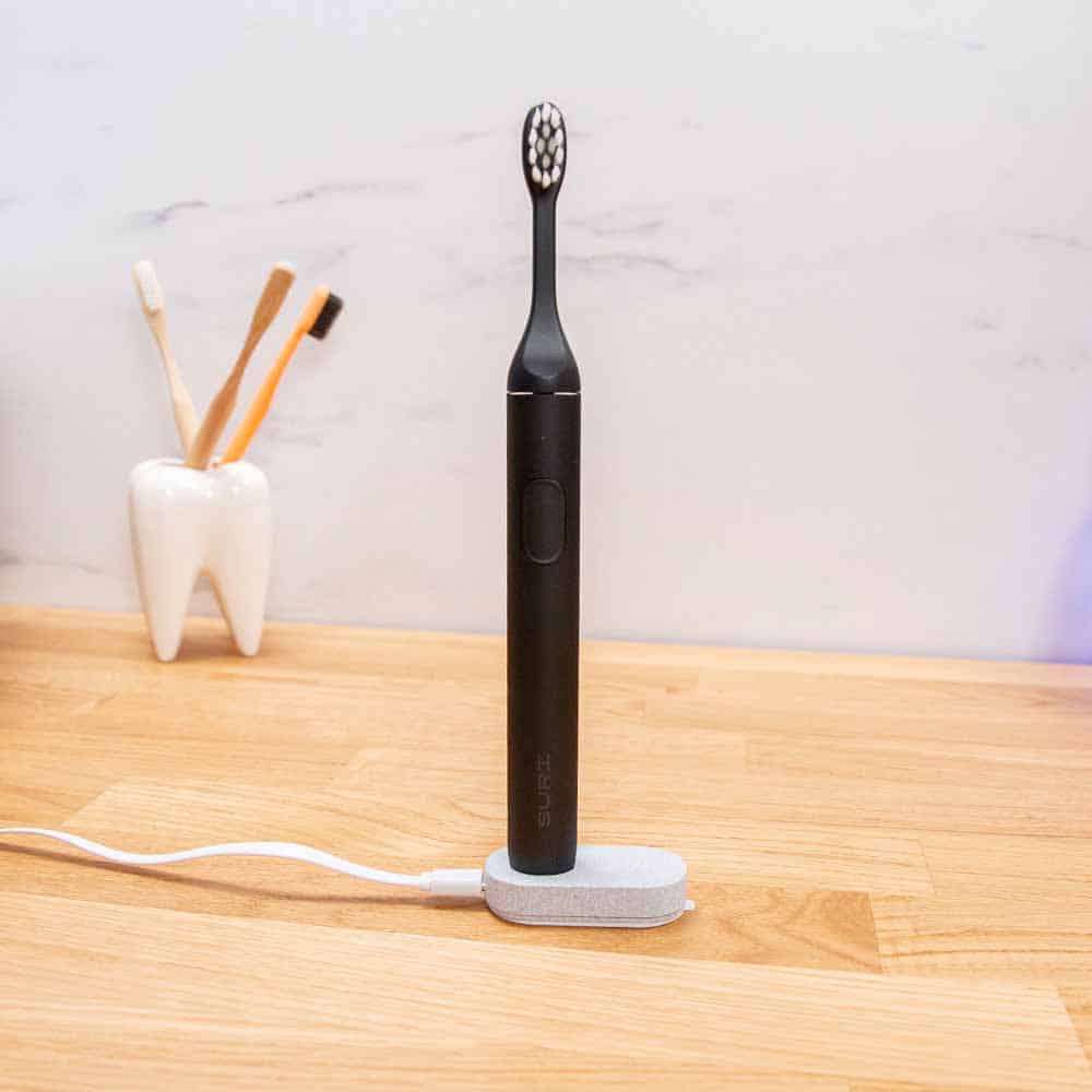 SURI sustainable electric toothbrush on charging stand