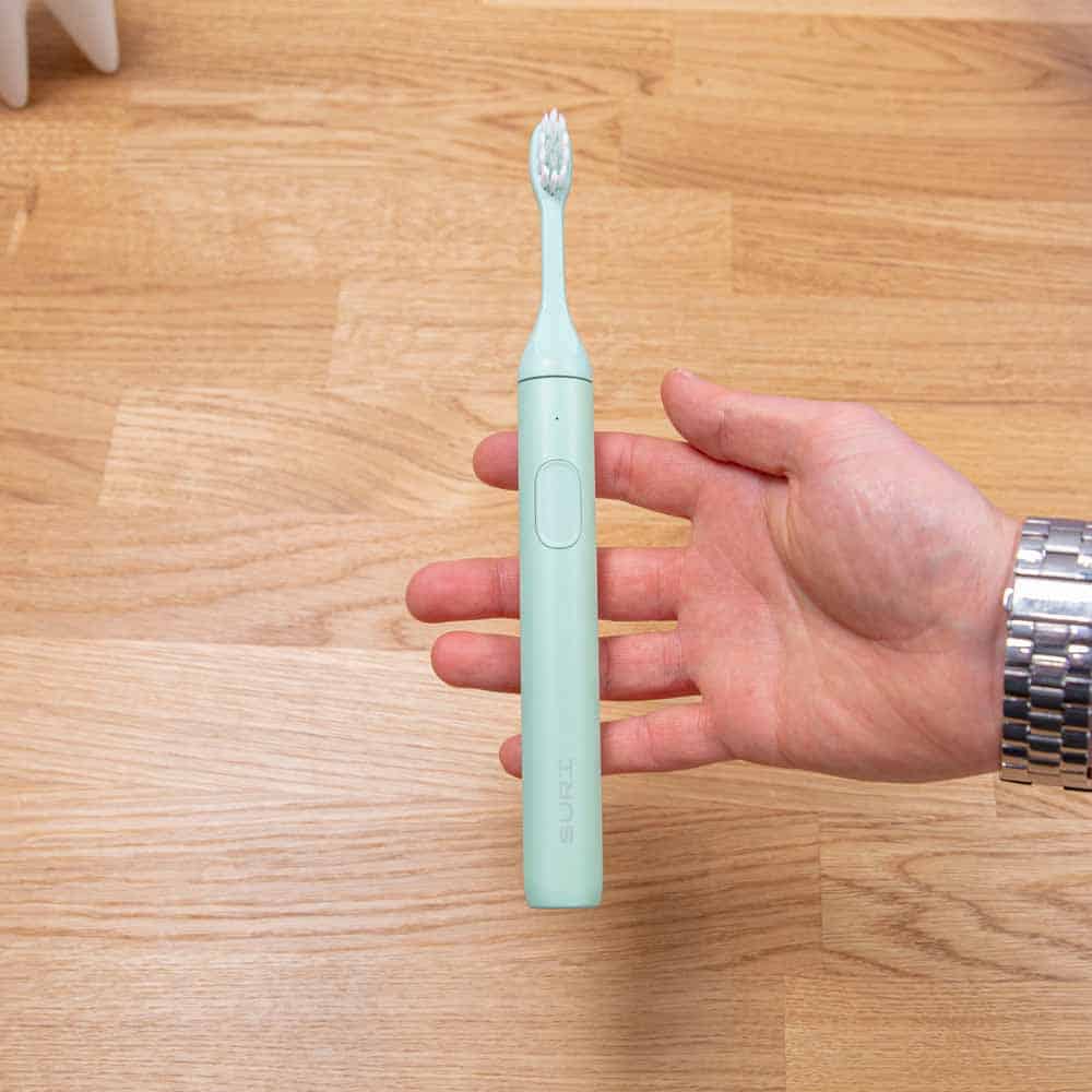 Fern Green SURI Sonic Toothbrush in the hand