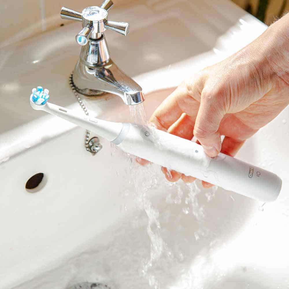 White Oral-B iO Series 4 under a tap