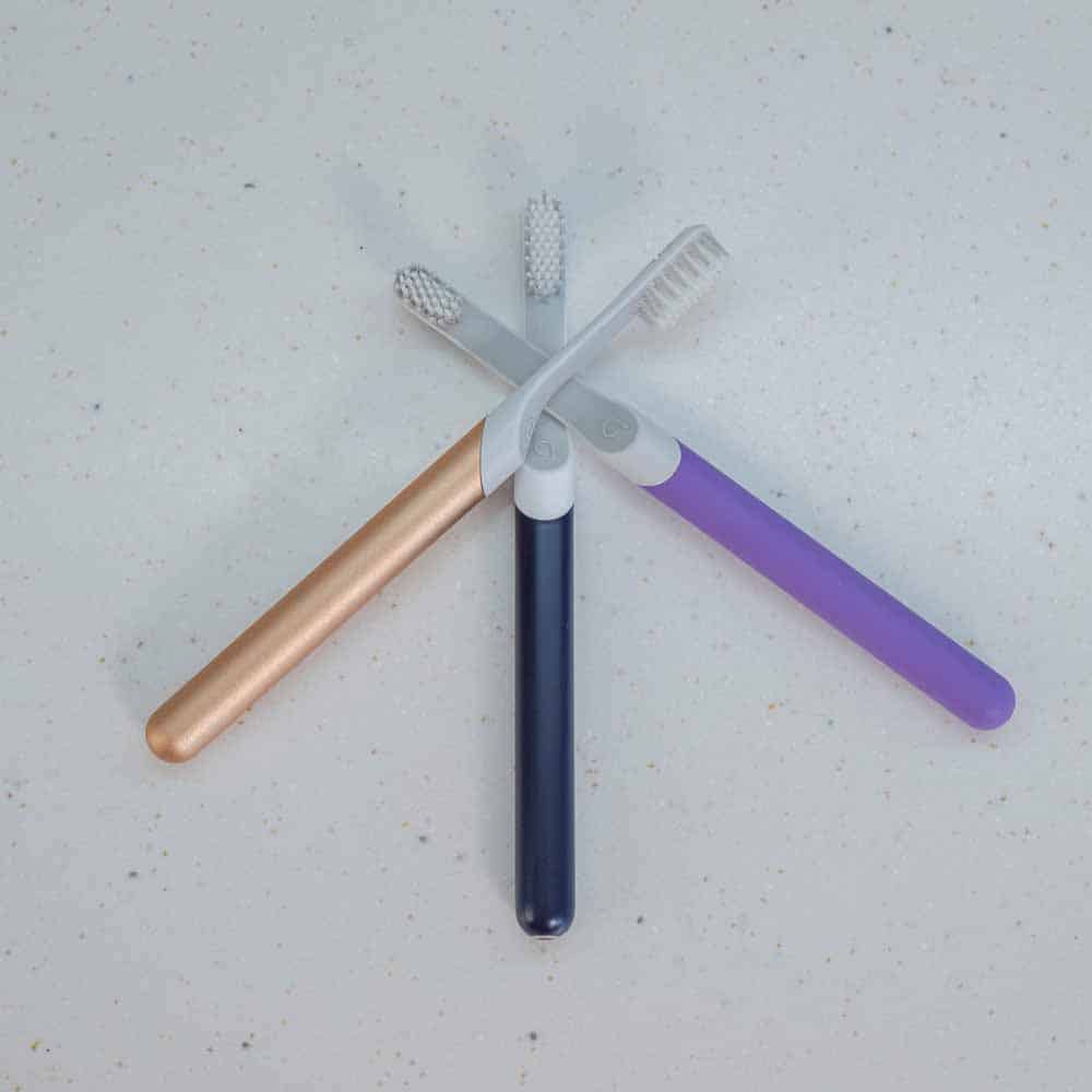 Different colored Quip toothbrushes