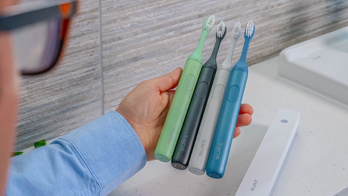 Multiple SURI toothbrushes in the hand