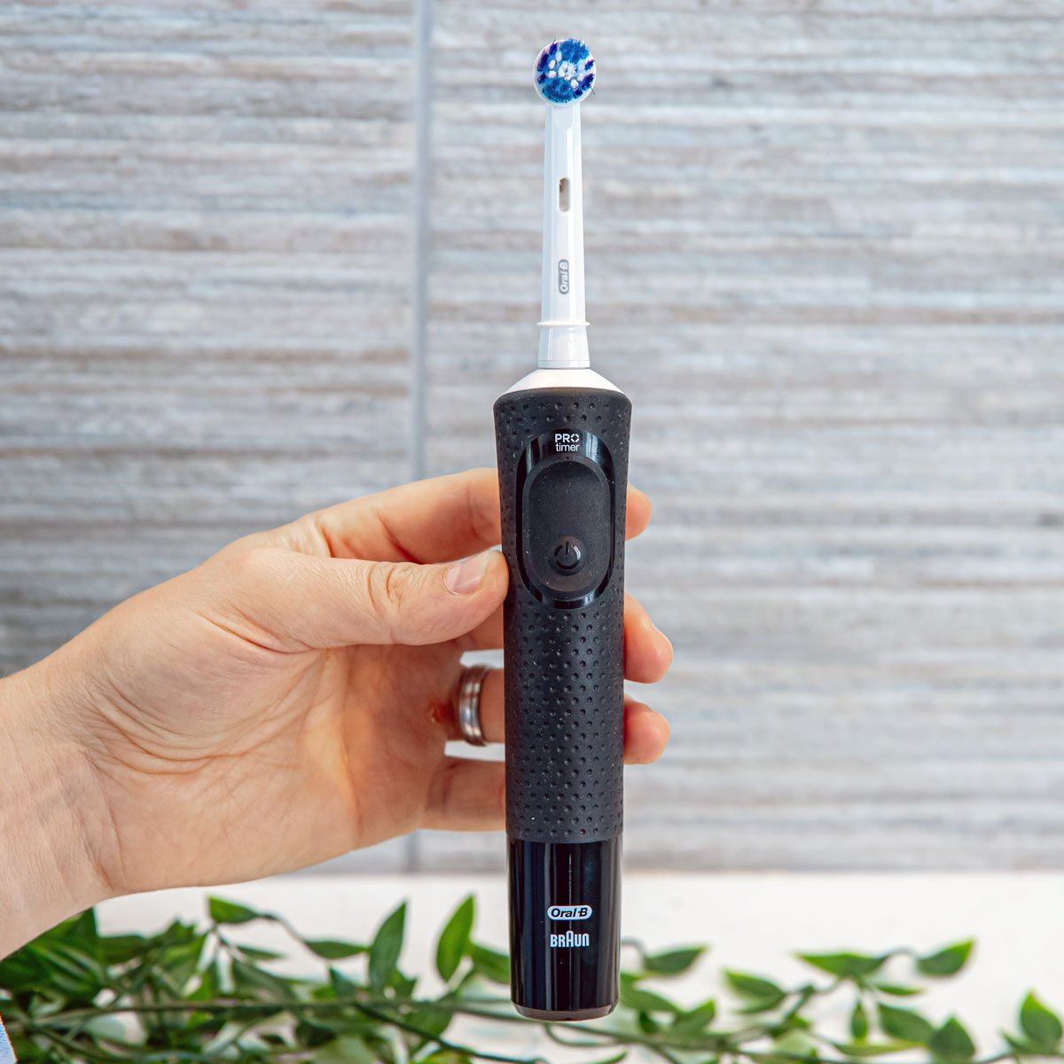 Black Oral-B Pro 500 held vertically in the hand