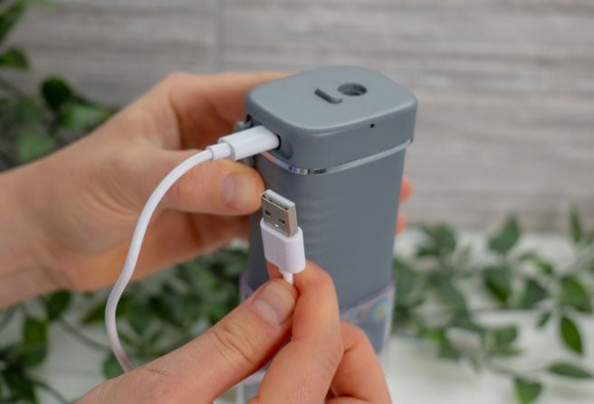 Water flosser with USB cable plugged into it