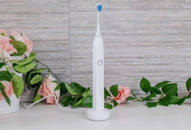 Electric toothbrush on its charging stand