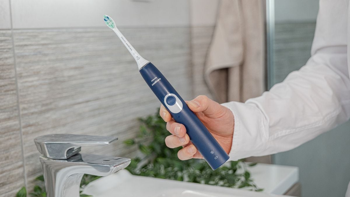 A Sonicare ProtectiveClean electric toothbrush being held in hand