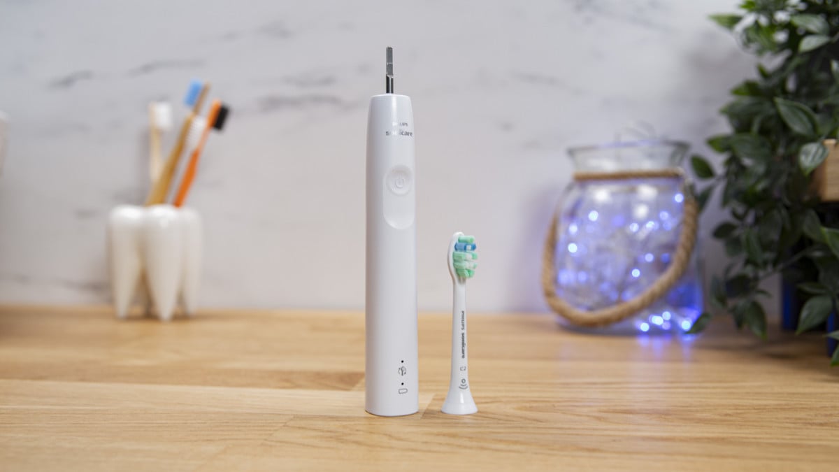 Sonicare 4100 Series with brush head removed and placed next to handle