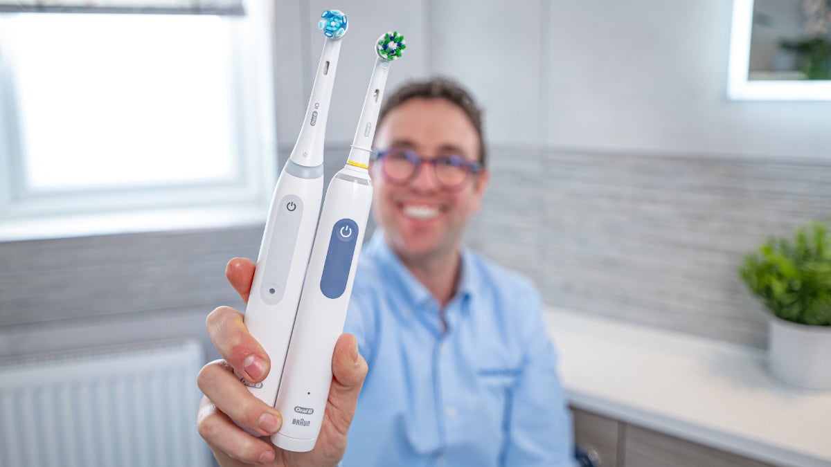 Jon holding Oral-B iO3 next to Oral-B Smart 1500